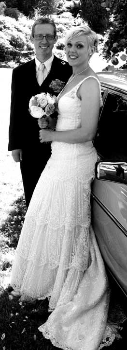 bride and groom at getaway car